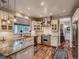 Bright kitchen featuring white cabinets, granite countertops, stainless steel appliances, and breakfast nook at 930 Kearney St, Denver, CO 80220