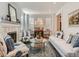 Cozy living room with a fireplace, plush seating, and ample natural light from the windows at 930 Kearney St, Denver, CO 80220