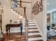 Elegant staircase with white risers, wood treads, and a gallery wall of Gathering photos at 930 Kearney St, Denver, CO 80220