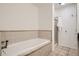 Clean white bathtub with light tan tile surround at 1200 Cherokee St # 206, Denver, CO 80204