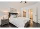 Primary bedroom with dark hardwood floors, ceiling fan, and ensuite bathroom at 1200 Cherokee St # 206, Denver, CO 80204