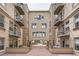 Exterior view of building with balconies overlooking an outdoor courtyard at 1200 Cherokee St # 206, Denver, CO 80204