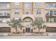 Building with arched entry, decorative facade, and mature trees at 1200 Cherokee St # 206, Denver, CO 80204
