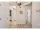 Bright hallway featuring tiled floors, access to the bathroom and laundry, and decorative lighting fixture at 1200 Cherokee St # 206, Denver, CO 80204