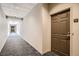 Hallway with dark brown door and carpeted floors at 1200 Cherokee St # 206, Denver, CO 80204