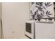 Laundry room with modern washer and dryer and decorative curtain at 1200 Cherokee St # 206, Denver, CO 80204