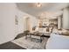 Inviting living room with hardwood floors, neutral furniture, and a view into the kitchen at 1200 Cherokee St # 206, Denver, CO 80204