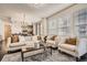 Bright living room featuring a tufted sofa and armchairs, and hardwood floors at 1200 Cherokee St # 206, Denver, CO 80204