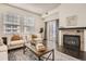 Cozy living room with a fireplace, neutral colored furniture, and natural light at 1200 Cherokee St # 206, Denver, CO 80204