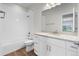 Bright bathroom with tile surround shower over tub, white cabinets, quartz countertop, and wood look vinyl flooring at 2165 Peralta Loop, Castle Rock, CO 80104