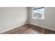 Bedroom with wood look vinyl flooring and a large window with view of neighboring homes at 2165 Peralta Loop, Castle Rock, CO 80104