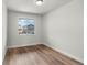 Bedroom with wood look vinyl flooring and a large window with view of neighboring homes at 2165 Peralta Loop, Castle Rock, CO 80104
