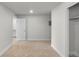 Bedroom with neutral carpet, light gray walls, bright natural light, and walk in closet at 2165 Peralta Loop, Castle Rock, CO 80104