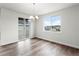 Bright dining room features hardwood floors, modern chandelier, and sliding glass doors to the deck at 2165 Peralta Loop, Castle Rock, CO 80104