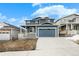 Beautiful blue two-story home with a covered front porch, two-car garage and landscaped yard at 2165 Peralta Loop, Castle Rock, CO 80104