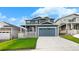 Charming blue two-story home with a covered front porch, a manicured lawn, and a two-car garage at 2165 Peralta Loop, Castle Rock, CO 80104