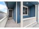 Inviting covered front porch with a stylish front door and a large window with charming shutters at 2165 Peralta Loop, Castle Rock, CO 80104