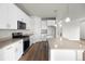Modern kitchen with white cabinets, stone countertops and an island at 2165 Peralta Loop, Castle Rock, CO 80104