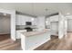 Modern kitchen with white cabinets, stone countertops and an island at 2165 Peralta Loop, Castle Rock, CO 80104