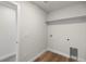 Laundry room with white walls, wood floors, shelving, and washer/dryer hookups at 2165 Peralta Loop, Castle Rock, CO 80104