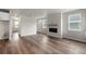 Open-concept living room features hardwood flooring and a modern fireplace with a wooden mantel at 2165 Peralta Loop, Castle Rock, CO 80104