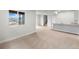 Open living room features neutral carpet and light gray walls with bright natural light and an open staircase at 2165 Peralta Loop, Castle Rock, CO 80104