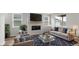 Staged living room with fireplace, TV, comfortable seating and decor at 2165 Peralta Loop, Castle Rock, CO 80104