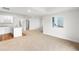 Bright open living area with carpet, white cabinets, and a large window at 2165 Peralta Loop, Castle Rock, CO 80104