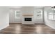 Bright living room with modern fireplace, hardwood floors, and plenty of natural light at 2165 Peralta Loop, Castle Rock, CO 80104