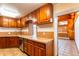 Kitchen with wood cabinets and tile countertops at 10250 W 80Th Ave, Arvada, CO 80005