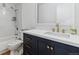 Updated bathroom with dark vanity, white quartz countertop, and gold fixtures at 775 S Alton Way # 2C, Denver, CO 80247