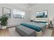 Second bedroom with teal bedding and plenty of natural light at 775 S Alton Way # 2C, Denver, CO 80247