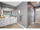 Bathroom with wood tile floors, gray walls, white cabinets and drawers, with a towel rack on the wall at 3091 Keepsake Way, Castle Rock, CO 80109