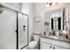 Modern bathroom featuring tiled shower with glass door, sleek vanity, and contemporary fixtures at 3091 Keepsake Way, Castle Rock, CO 80109