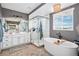Elegant bathroom featuring a soaking tub, glass enclosed shower, double vanity, and modern fixtures at 3091 Keepsake Way, Castle Rock, CO 80109