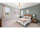 This bright bedroom features a stylish light fixture and neutral decor at 3091 Keepsake Way, Castle Rock, CO 80109