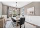 Bright dining room with modern chandelier, large windows, and stylish decor for elegant meals at 3091 Keepsake Way, Castle Rock, CO 80109