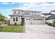 Beautiful two-story home featuring gray siding, stone accents, a three-car garage, and a well-manicured front lawn at 3091 Keepsake Way, Castle Rock, CO 80109