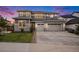 Beautiful two-story home featuring gray siding, stone accents, a three-car garage, and a well-manicured front lawn at 3091 Keepsake Way, Castle Rock, CO 80109