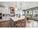 Bright kitchen with stainless steel appliances, white cabinets, a large island, and a cozy breakfast nook at 3091 Keepsake Way, Castle Rock, CO 80109