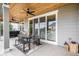 Covered outdoor patio with seating area and sliding glass doors to interior at 3091 Keepsake Way, Castle Rock, CO 80109
