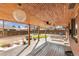 Spacious wooden back deck with ceiling fans, wooden plank ceiling and an expansive backyard at 2700 S High St, Denver, CO 80210