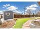 Spacious backyard featuring artificial grass, a shed, and a stone pathway, creating an inviting outdoor space at 2700 S High St, Denver, CO 80210