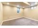 Finished basement with neutral walls, new carpet, and natural light creating a warm and inviting atmosphere at 2700 S High St, Denver, CO 80210