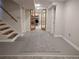 Finished basement showcasing carpets, open staircase, and french doors at 2700 S High St, Denver, CO 80210