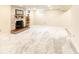 Spacious basement with a cozy brick fireplace and plush carpeting at 2700 S High St, Denver, CO 80210