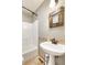 Bathroom featuring a pedestal sink, decorative mirror, and shower at 2700 S High St, Denver, CO 80210