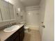 Well-lit bathroom featuring a vanity with sink, a toilet, a tiled shower-tub combination, and a mirror at 2261 S Buckley Rd # 102, Aurora, CO 80013