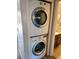 Efficient laundry area showcasing a stacked washer and dryer set for convenient in-home laundry at 2261 S Buckley Rd # 102, Aurora, CO 80013