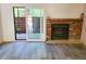 The living room features a traditional brick fireplace and opens to an outdoor area through sliding glass doors at 2261 S Buckley Rd # 102, Aurora, CO 80013